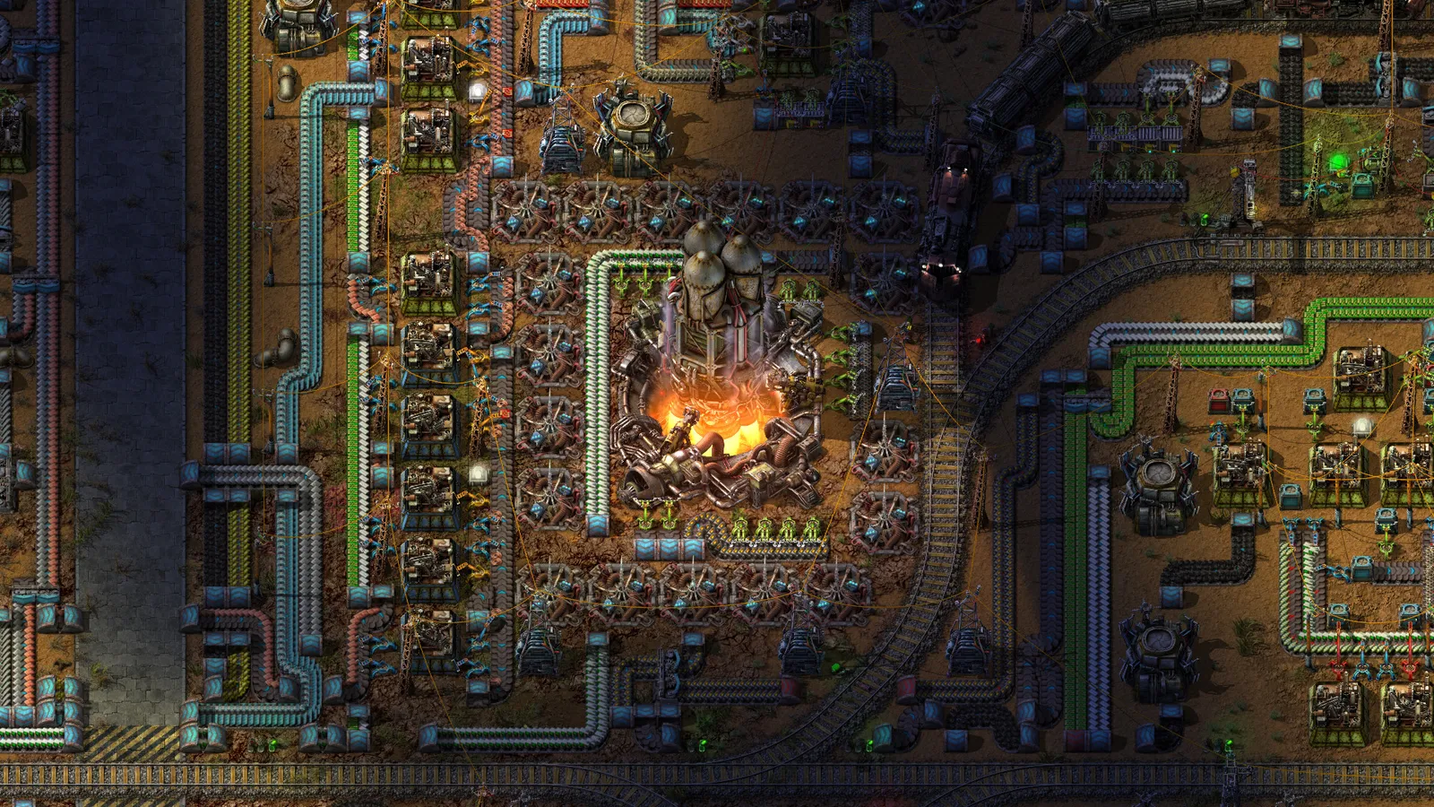 Fábrica em Factorio vista de cima, com esteiras, máquinas, trilhos e um foguete sendo lançado no centro.